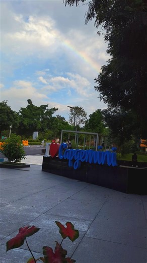 Capgemini India on Instagram: "Some days at work surprise you in the best way. This day, the sky decided to steal the show 🌈 A rainbow arcing across the sky, turning a simple walk into a moment of quiet awe. No announcements. No agenda. Just a pause that felt perfectly timed 💭 From the basketball court 🏀 to the canteen, past the fountain and familiar walkways, our campus looked a little different today. Captured by Zahid Ahmed Khan (@_khan_walker_), this moment reminds us that the future we b