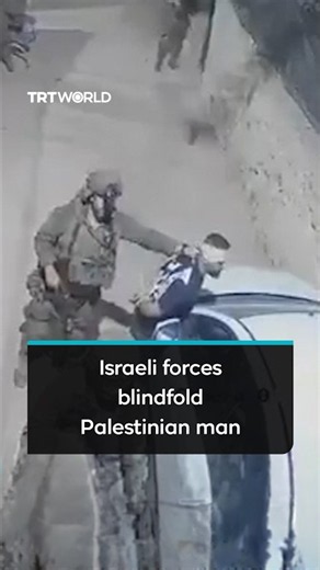 Israeli forces assault blindfolded Palestinian during West Bank raid