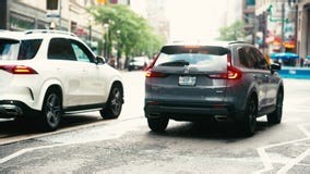 Toronto, Canada - June 11, 2026: Honda CR-V and Mercedes-Benz SUVs Driving Through Downtown Traffic on Wet Yonge Street