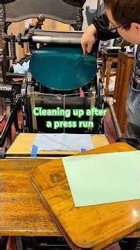 Cleaning green rubber base ink off the press after a press run to print holiday cards