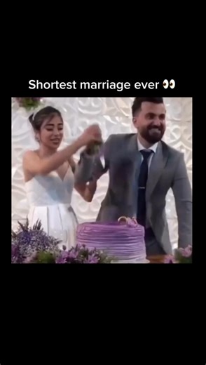 Daily videos on Instagram: "The celebration was in full swing as the newlyweds stood before their towering purple cake, ready to share their first sweet moment as a married couple. With a playful glint in his eye, the groom suddenly grabbed the bride’s head and playfully shoved her face directly into the frosting. What started as a lighthearted prank quickly turned into a messy disaster as the bride emerged, gasping for air and wiping thick purple cream from her eyes. The laughter in the room di