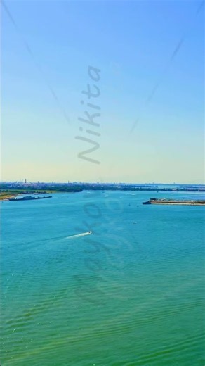 Vertical video. Venice, Italy. Aerial view over the Venetian Lagoon, boats navigating wide turquo...