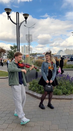 The girl is shocked by the violinist playing for her