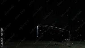 Destroying and hitting a computer keyboard on a floor, particles flying in the air, slow motion shot. Professional life and job burnout concepts.