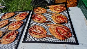 Broiled flounder flatfish on a grid at a outdoor table