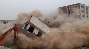 Near-miss during risky building demolition in China