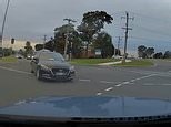 Dashcam footage captures two cars colliding at a busy intersection
