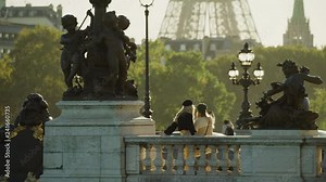 Women posing for cell phone selfie near statues on Pont Alexandre / Paris, Ile de France, France