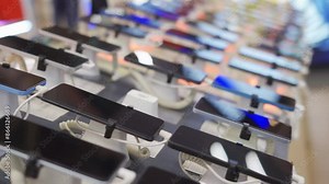A lot of smartphone models on display at the exhibition stand of an electronics store