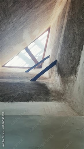 Tall, minimally designed ceiling featuring a triangular-shaped skylight window in Al Fahidi museum in Dubai, vertical video