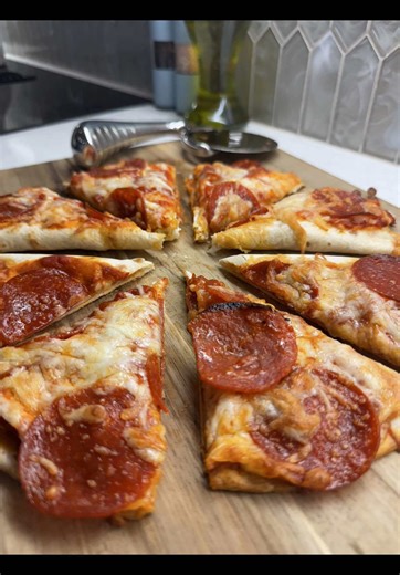 Freshly baked pepperoni pizza slices on wooden board, choose which slice to eat
