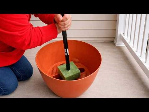 Stick a Dollar Store broom into a planter for this BRILLIANT front porch idea!