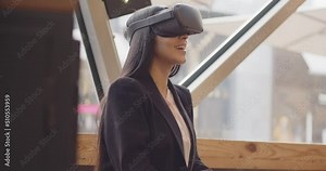 Future VR Education Technology beautiful multi-ethnic woman using virtual reality headset to scroll menu of a restaurant. Woman uses Augmented Reality VR Glasses to book an appointment.