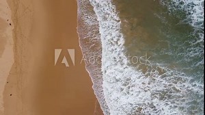 Top-down drone footage of waves at an Australian beach.