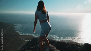 woman standing up on top of table mountain and admiring the view