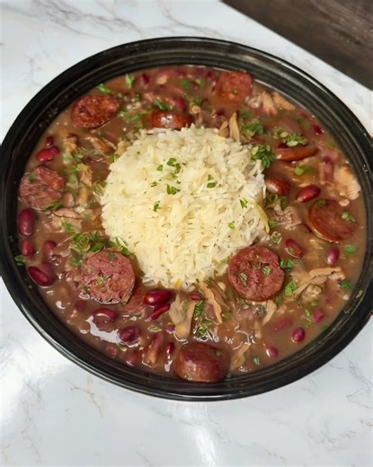 Louisiana Red Beans and Rice with Smoked Sausage YAY OR NAY! Ingredients: 1 lb dry red kidney beans, soaked overnight and drained 1 tbsp oil or butter 1 onion, diced 1 green bell pepper, diced 2 celery stalks, diced 3 cloves garlic, minced 1 lb smoked sausage, sliced (andouille preferred) 1 tsp thyme 1 tsp paprika ½ tsp cayenne pepper (adjust to taste) 2 bay leaves 6 cups chicken broth or water Salt & pepper to taste Cooked white rice, for serving Green onions or parsley, for garnish (optional) 