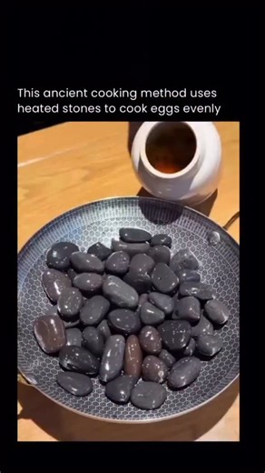 Hack The Void on Instagram: "Eggs cooked in hot fried gravel rely on pure heat transfer rather than a pan or oil. The gravel is heated over an open flame until it reaches extremely high temperatures, storing thermal energy across thousands of small stones. When an egg is buried inside, the heat transfers evenly from all sides through conduction, cooking the egg without direct flame contact. The shell protects the egg from burning while the intense, surrounding heat rapidly sets the whites and co