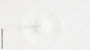 Fresh milk single drop splashing in a milk pool.With circle ripples.