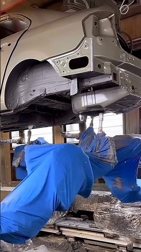 How do robots complete the painting task on the automotive production line?