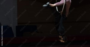 Gymnastics, woman is doing a split on a man who is doing an upside down split 4k