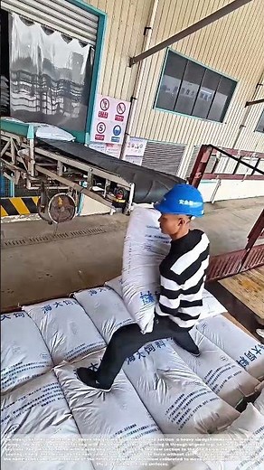 Stacking the Feed: How a Man in a Truck Bed Builds a Wall of Sacks