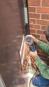 Cutting out an opening in this steel door for a mail slot for one of our commercial customers. | HandyVets