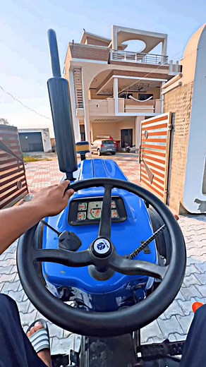 Person Drives Blue Tractor in Residential Area