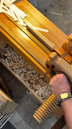 trimming thin strips of wood precisely using a manual paper guillotine style cutter on workbench