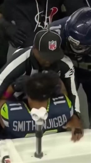 Referee Nathan Jones heroically protects Jaxon Smith-Njigba vs the Texas sideline, and if we had more referees like him, the NFL would be a better place #nfl #seahawks #nathanjones | Michael Bassano