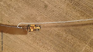 The pipe laying machine digs the ground and lays the pipe in the field. Creation of a drainage system.
