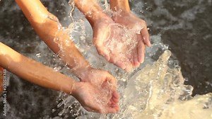 Hands of young people recieve water from irrigation pipe metaphor sustainable lifestyle, ecology system and environment concept.