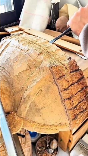 Hand carving turtle shell pattern into wooden surface