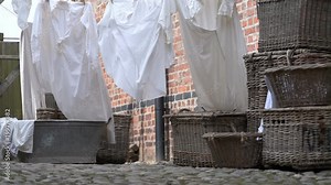 Old fashioned washing baskets and laundry drying on a line. Stock Video