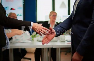Satisfied businessman company employer wearing suit handshake new employee get hired at job interview, male hr manager employ successful candidate shake hand at business meeting, placement concept