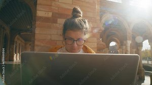 Young student work on laptop at university campus. Red brick old school empty building. Working on phd project or school assignment. Homework for postgraduate education Stock Video