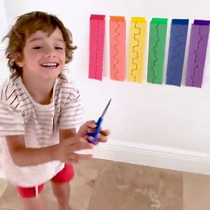 ✂️ SCISSOR SKILLS // Here’s a fun way to practice scissor skills! 🤩 I got my kiddos on their feet with this vertical set up! 🌈 By making activities eye-level, I’ve noticed how concentration and attention is much more focused, plus it’s great for strengthening arms and shoulder muscles! 💪 - Get Color Tape Set Here >> https://geni.us/CyaAPPb | 7 Days of Play