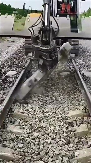the repair process on a railway track using heavy equipment to make the work easier
