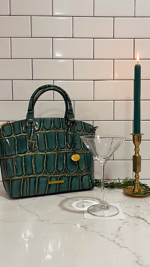 Mystic Green Nerina is here, and is sophistication at it’s finest. The rich green color, bold gold wash and bronze hardware combination is stunning and bound to turn heads ✨ Be the main character in your holiday movie this season! | Brahmin Handbags