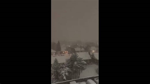 Heavy nighttime snowfall blankets neighborhood during blizzard in Hamilton, Ontario, Canada