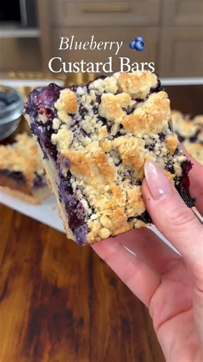 BLUEBERRY CUSTARD BARS 💙 If you love creamy desserts with a buttery base, these are about to be your new favorite. A tender shortbread-style crust, smooth pastry cream custard, a layer of blueberry jam, and a lightly crumbly topping that bakes up golden and perfect. Every layer has a purpose, and together they’re just really, really good. They’re rich without being heavy, slice clean, and somehow taste even better once they’ve chilled. This is the kind of dessert you make once and immediately p