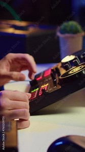 Vertical Video Music producer recording piano keyboard notes and editing them on a mixing console in his home studio. Skilled artist implementing advanced sound mixing techniques, equalization tools