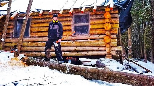 Taking down the dangerous tree that is leaning over the log cabin. | Wright