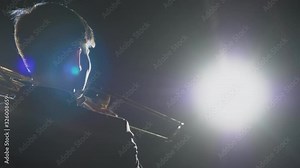Musician playing trumpet. Live instrumental popular classic melody on symphony hall by talented art people in theatre stage light. Occupation of music soloist on equipment on opera performance closeup
