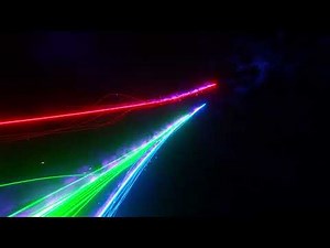 Multicolored laser trails flying in space. Infinitely looped animation