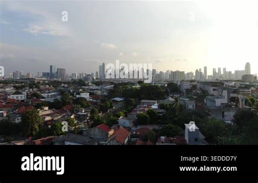 Aerial Cityscape of Dense Urban Neighborhood and Modern Skyscrapers under Hazy Polluted Sky. Wide Metropolitan Landscape with Residential Houses, Mosque Tower, and Infrastructure Development. Stunning Contrast of Urban Growth and Air Quality Stock Video Footage - Alamy