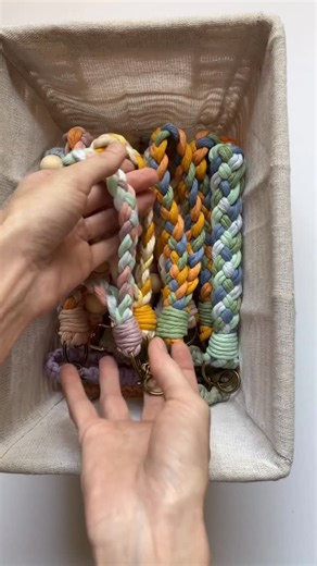 Megan | Macrame Gifts & Tutorials on Instagram: "Macrame Braided Keychain 💙💚🧡✨ #handmademarket #behindthescenes #howto #macrame #megsmodernmacrame #shopmegsmodernmacrame #macrameshop #handmadecommunity #macramemakers #macramegift #macrameidea #diy #keychains #howtomacrame #gatheringknot #beginnerknot #beginnermacrame #beginnerartist #macramemovement #fiberart #keychaindiy #macramebraid #macramekeychain #macramecharm #fiberart #macramechristmas #relaxingtutorial #shophandmade #farmersmarket #m