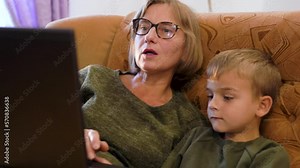 Grandson showing grandparents how to use computer
