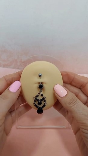 All black dangle belly rings like this one are the perfect jewelry to create a dark theme for Halloween. Get in the spirit now before the day comes and use it to elevate the look of your costumes! #bodypiercings #bodyjewellery #bodyjewelry #nostrilpiercings #girlwithpiercings #jewelryaddict #septumring #piercingshop #piercing2me ##piercinglove #instapiercing #piercingjewelry #lovepiercings #nostril #piercedgirl #trendyjewelry #piercinglife #surgical #piercedchicks #surgicalsteel #cubiczirconia #
