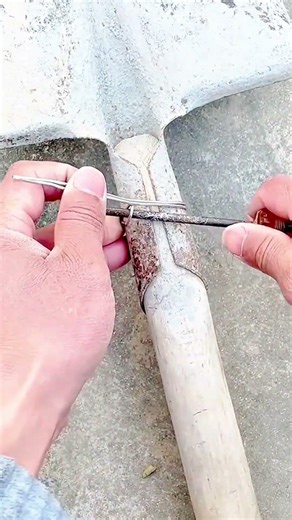 repairing shovel handle with metal wire binding to strengthen connection for better tool durability