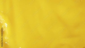 Close-up fresh orange juice mixing flowing and splashing slow motion shot, tropical fruit juice mix and splash being poured into large container